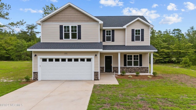 view of front of home with a front yard and a garage