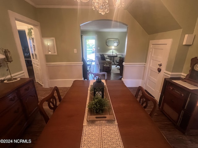 dining room with baseboards, a notable chandelier, arched walkways, and crown molding