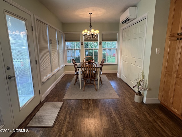 dining room featuring a chandelier, dark wood-type flooring, a wall mounted AC, and baseboards