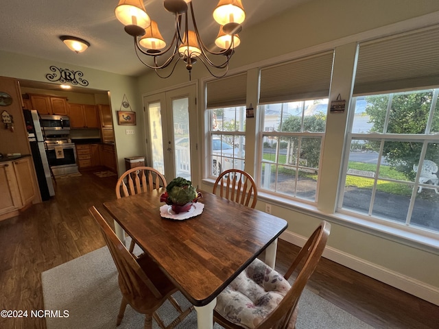 dining space featuring baseboards, dark wood finished floors, and an inviting chandelier