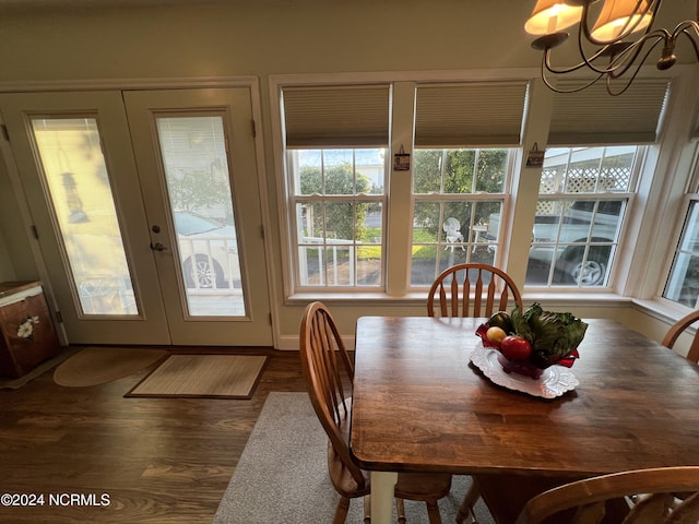 dining room featuring a chandelier, french doors, and dark wood-type flooring