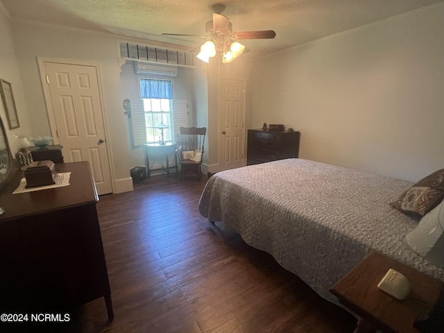 bedroom featuring a ceiling fan, dark wood-style flooring, and a textured ceiling