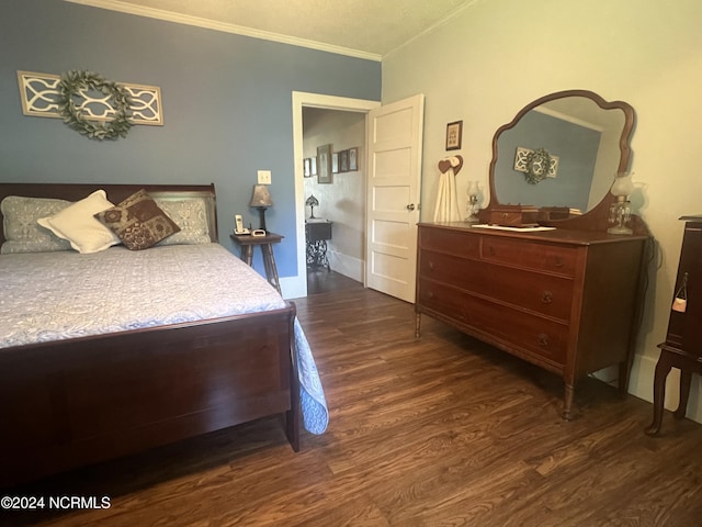 bedroom with crown molding and dark wood-style flooring