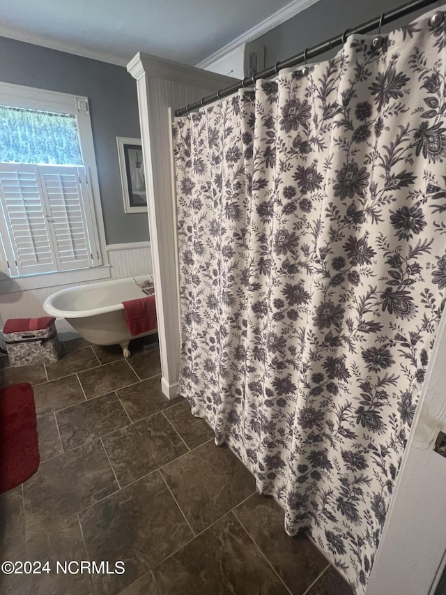 full bathroom with ornamental molding and a wainscoted wall