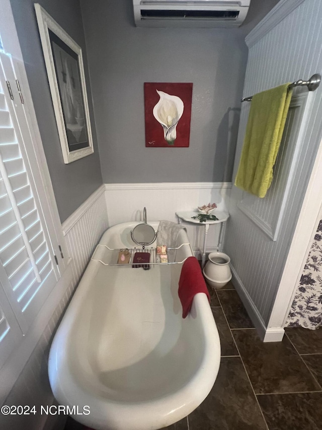 bathroom featuring an AC wall unit, wainscoting, and tile patterned floors