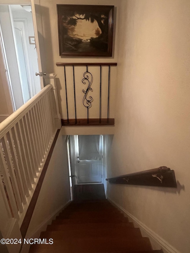 staircase featuring baseboards