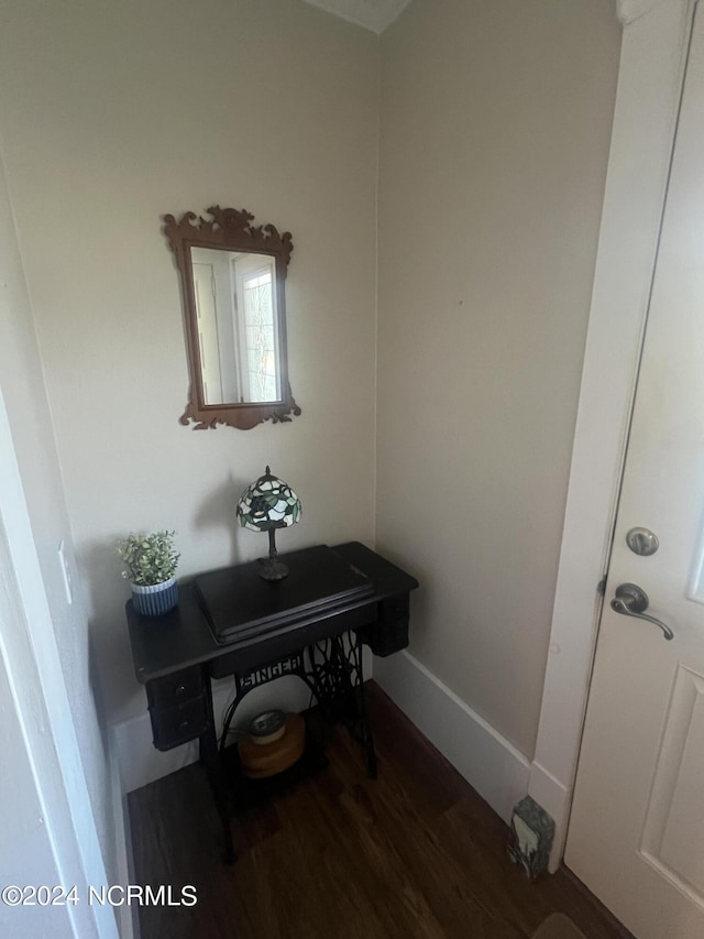 interior space with dark wood-style floors and baseboards