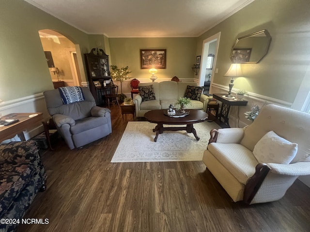 living room with arched walkways, dark wood-type flooring, and ornamental molding