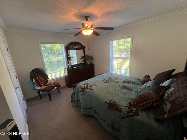 bedroom featuring a textured ceiling, ceiling fan, carpet floors, and ornamental molding