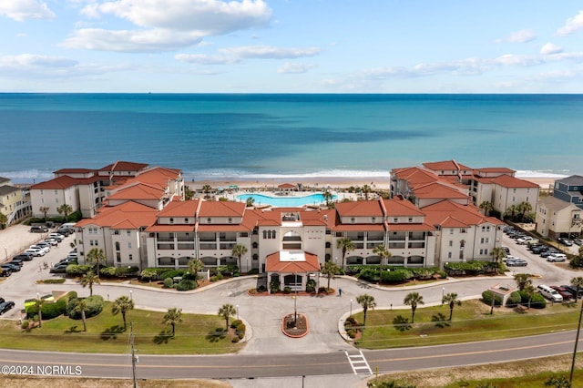 drone / aerial view featuring a beach view and a water view