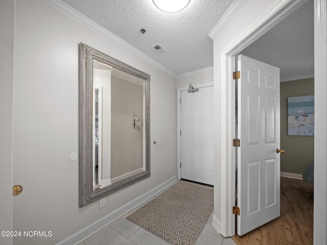 bathroom featuring tile floors, a textured ceiling, and crown molding