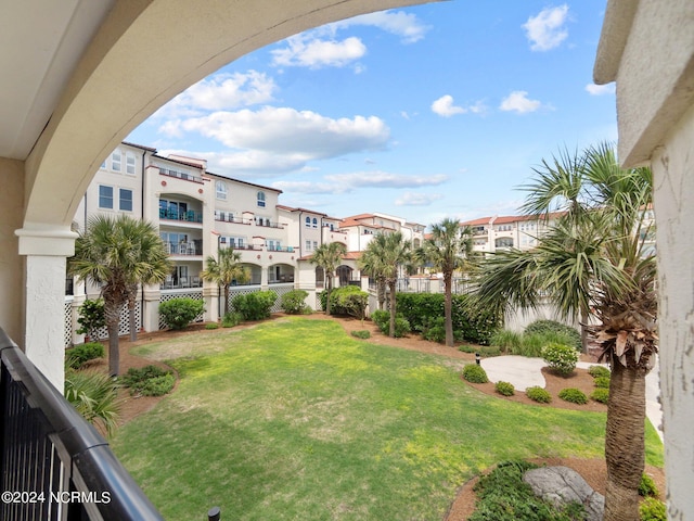 view of yard with a balcony