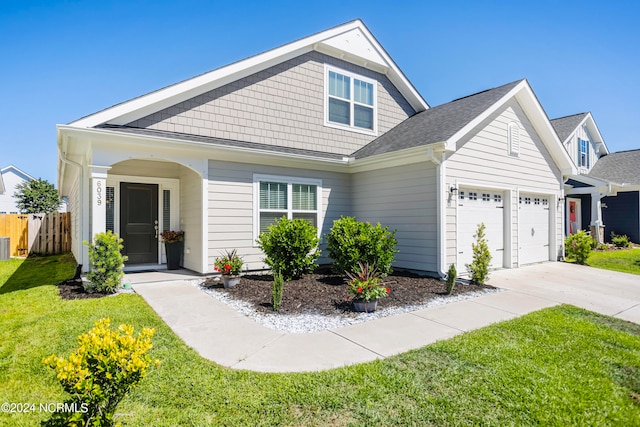 view of front facade featuring a garage and a front lawn