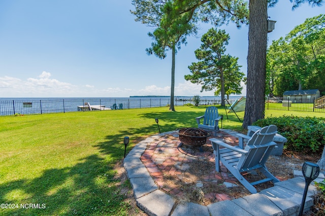 view of yard featuring a fire pit and a water view