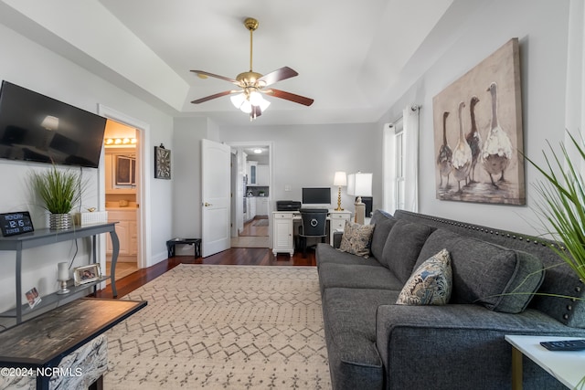 living room with dark hardwood / wood-style floors and ceiling fan