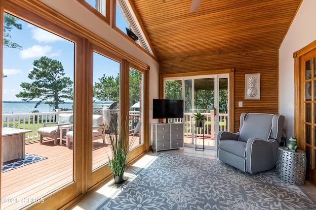 unfurnished sunroom with a water view, lofted ceiling, and wood ceiling