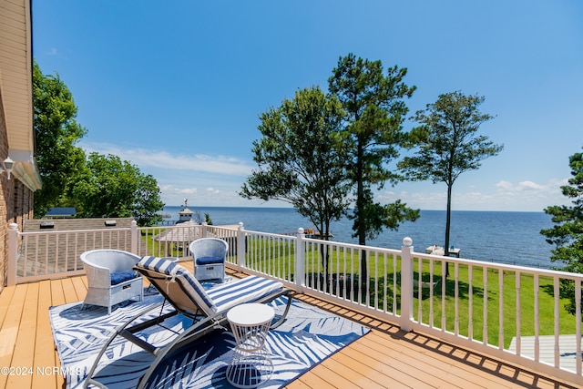 wooden terrace featuring a yard and a water view