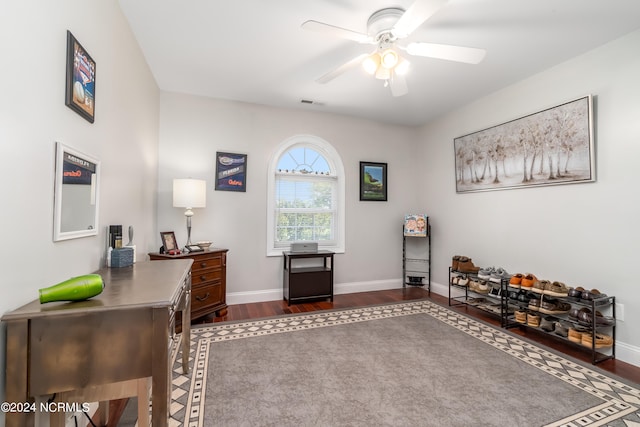 interior space featuring ceiling fan and dark wood-type flooring