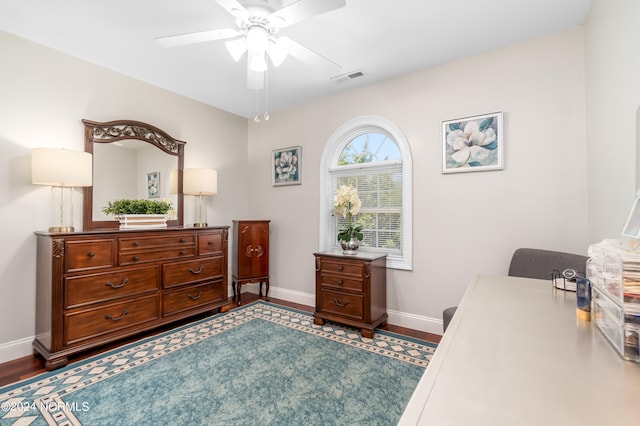 bedroom featuring ceiling fan and dark wood-type flooring