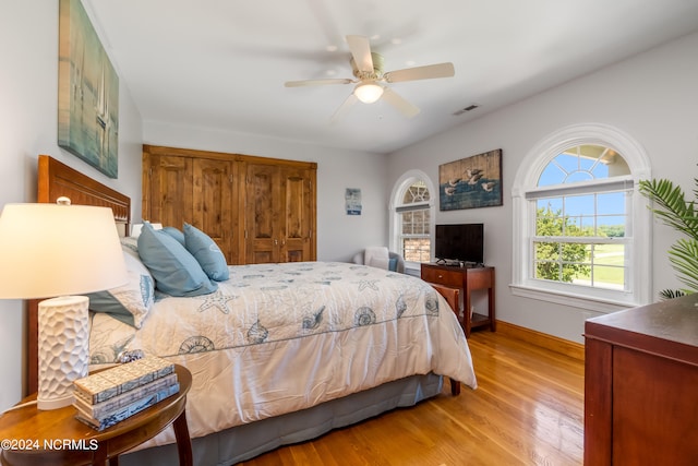 bedroom with ceiling fan and light hardwood / wood-style flooring