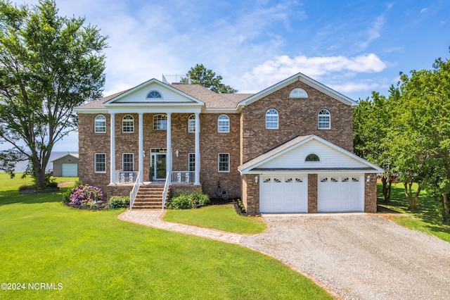 view of front of house with covered porch and a front yard