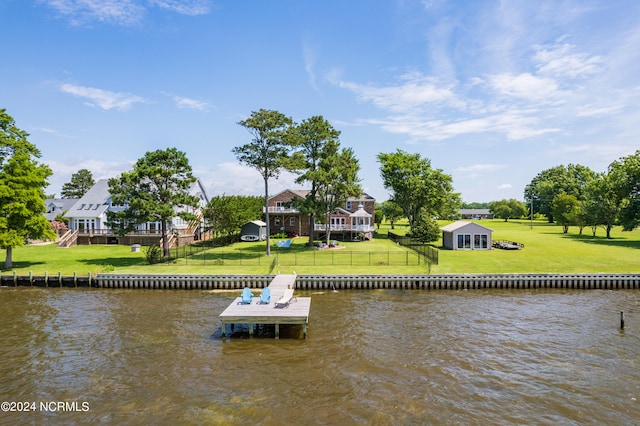 dock area with a yard and a water view