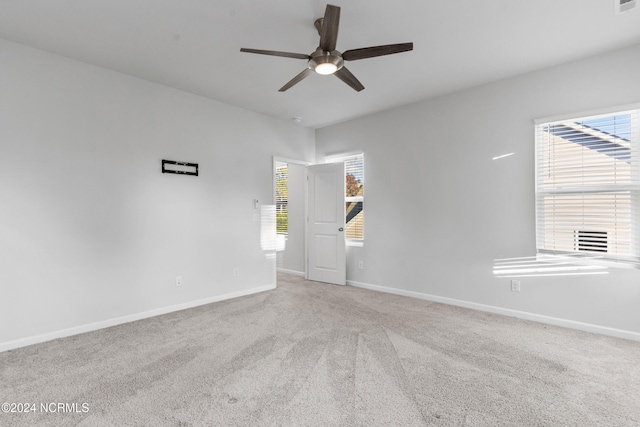 unfurnished room with carpet, baseboards, and a ceiling fan