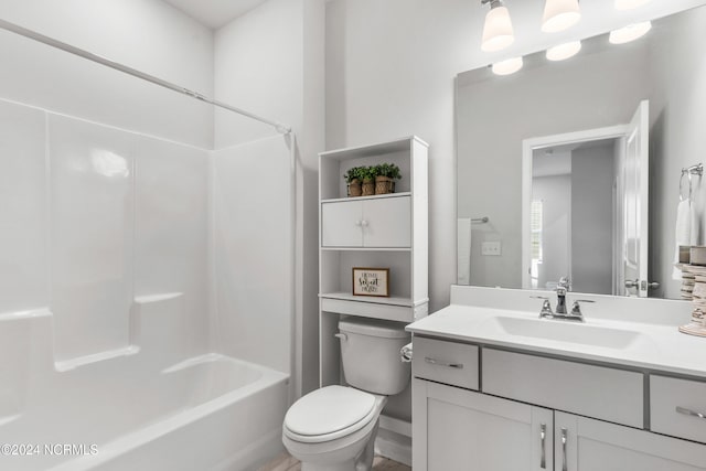 full bathroom featuring  shower combination, vanity, and toilet