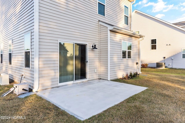 rear view of property featuring a lawn and a patio