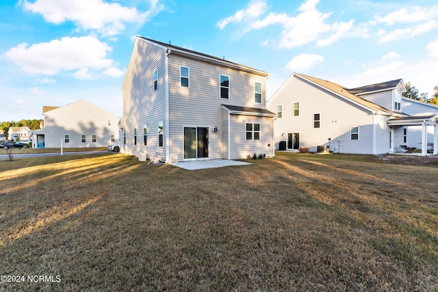 rear view of property with a patio area and a lawn