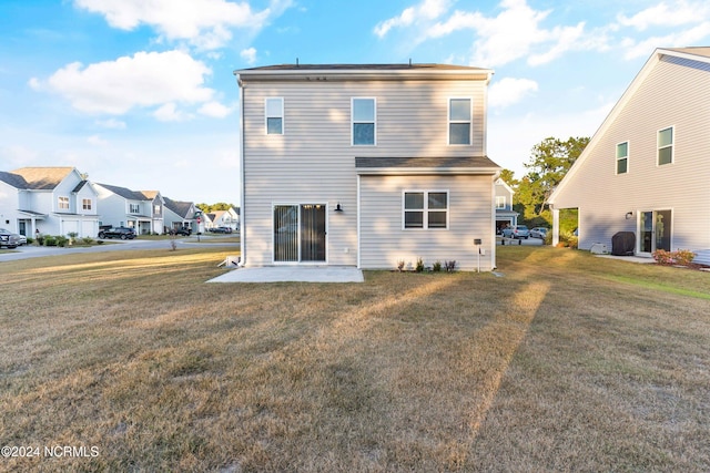 rear view of property featuring a patio and a lawn