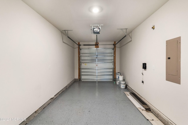 garage featuring electric panel, baseboards, and a garage door opener