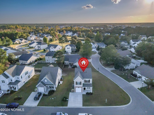 aerial view at dusk featuring a residential view