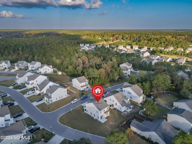 aerial view featuring a residential view and a wooded view