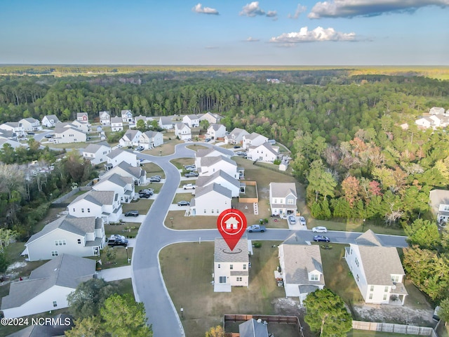 birds eye view of property featuring a residential view and a view of trees