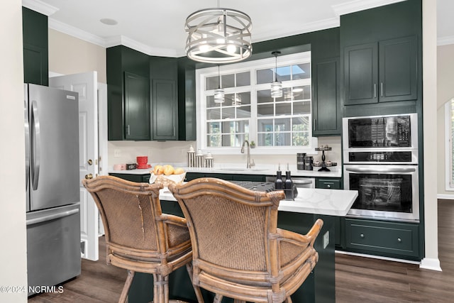 kitchen featuring appliances with stainless steel finishes, dark hardwood / wood-style floors, sink, and decorative light fixtures