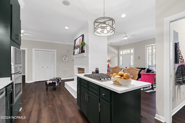 kitchen with a center island, dark hardwood / wood-style floors, decorative light fixtures, and crown molding