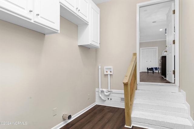 stairway featuring ornamental molding and hardwood / wood-style floors