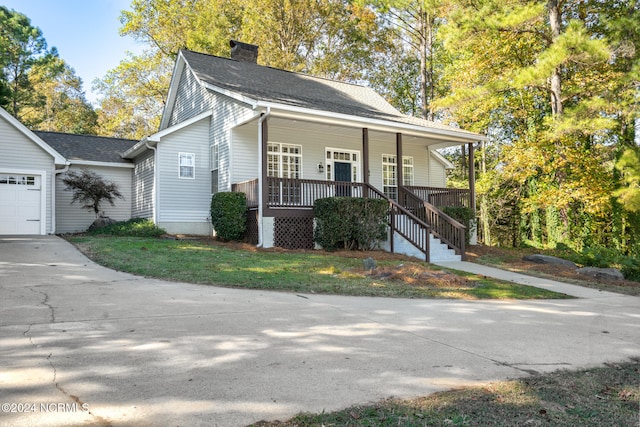 view of front of home with covered porch and a garage