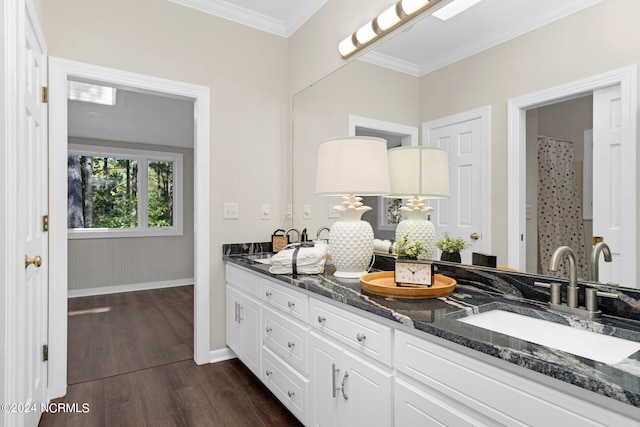 bathroom featuring vanity, crown molding, and wood-type flooring