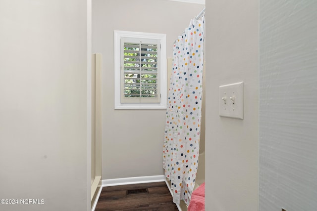 bathroom with hardwood / wood-style flooring