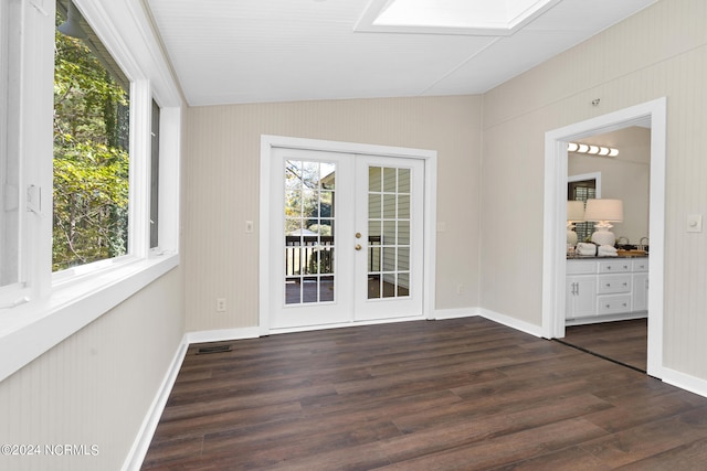 empty room with french doors, dark wood-type flooring, and plenty of natural light