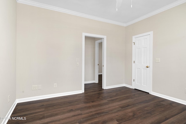 empty room featuring dark wood-type flooring and crown molding