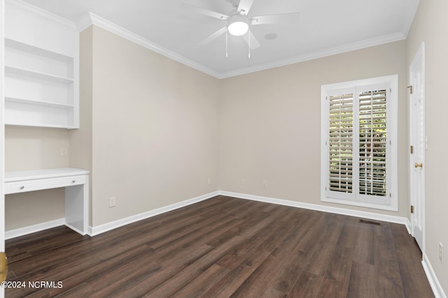 unfurnished room featuring built in desk, crown molding, and dark hardwood / wood-style floors