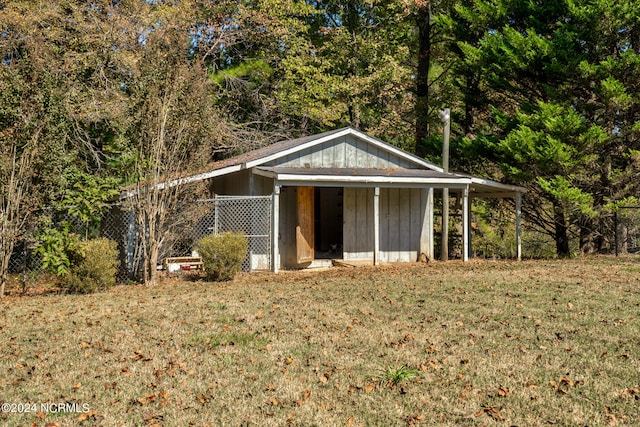 view of outbuilding with a yard