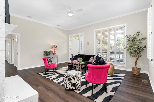 living room with ornamental molding, dark wood-type flooring, and ceiling fan