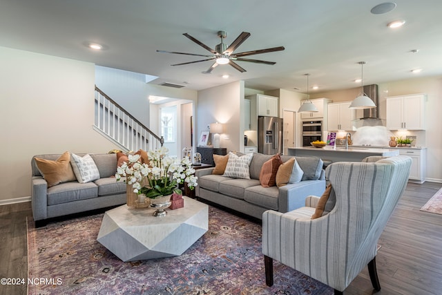 living room with sink, dark hardwood / wood-style flooring, and ceiling fan