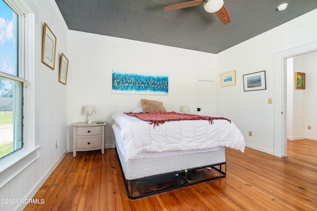 bedroom featuring wood-type flooring and ceiling fan