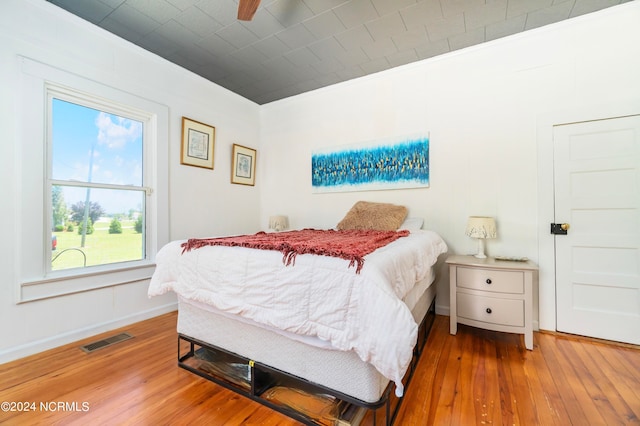 bedroom with ceiling fan and hardwood / wood-style flooring