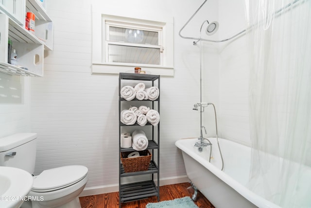 bathroom featuring wood-type flooring and toilet